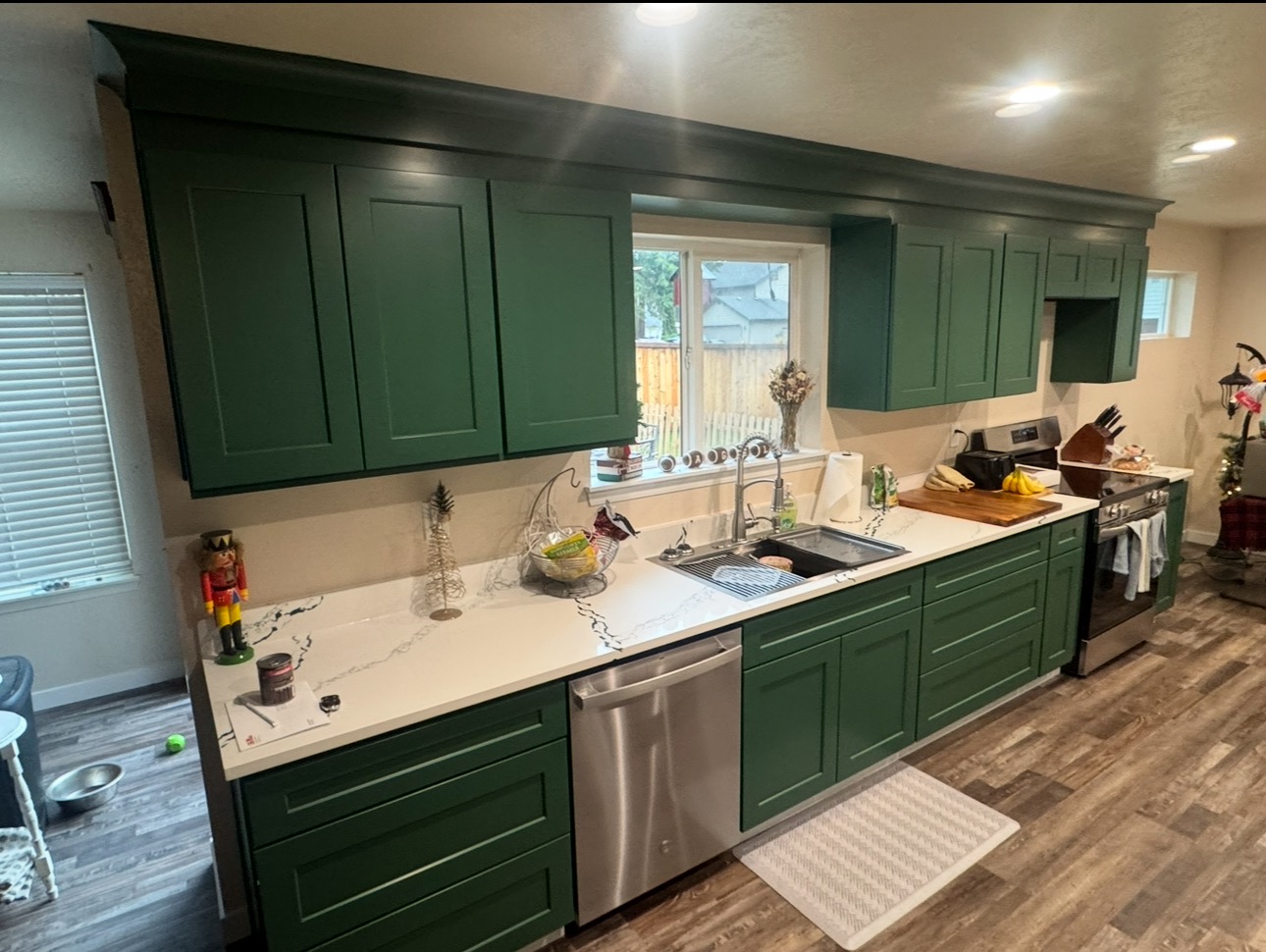 Finished kitchen with deep green cabinets